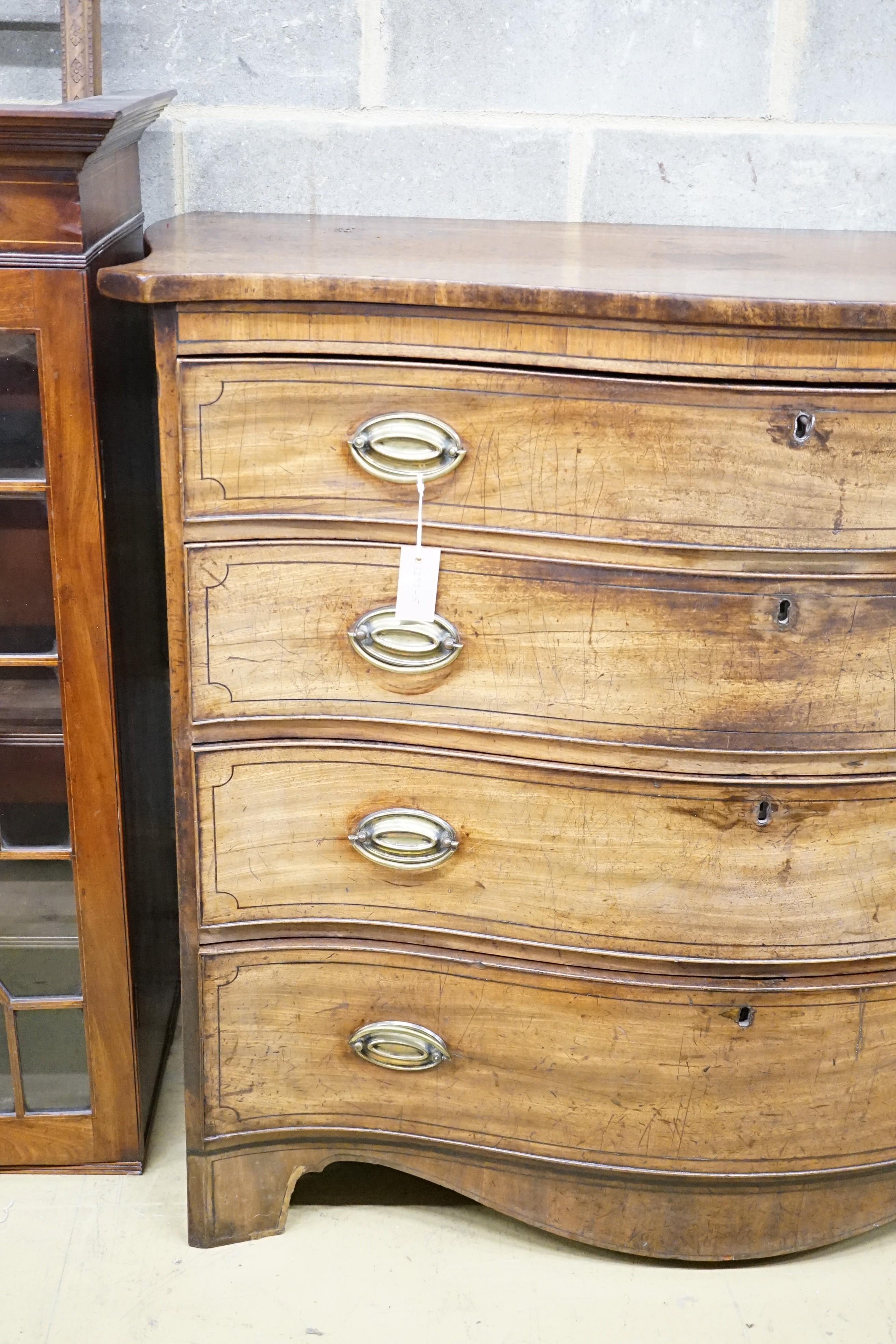 A George III mahogany serpentine chest with ebony stringing and four graduated long drawers, the top drawer divided into three, width 120cm, height 104cm, depth 59cm